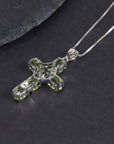 back side of silver cross necklace with peridot