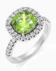Close-up of Cushion Cut Peridot Ring in Sterling Silver, showing its sparkling halo design with brilliant diamond alternatives around a green peridot.