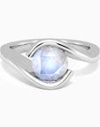 Round moonstone ring in a wave-style semi bezel setting, crafted in rhodium-plated sterling silver by Irosk