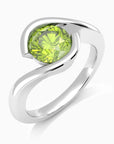 Angled view of peridot bezel ring showing semi-bezel setting and polished silver finish.

