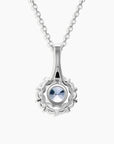 Close-up view of Alexandrite pendant with halo setting and brilliant light reflection