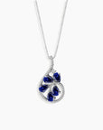 Teardrop-shaped sapphire pendant necklace in sterling silver featuring blue gemstones arranged in a floral pattern, perfect for adding elegance to any outfit.