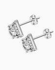 Close-up shot of the square moissanite stud earrings, detailing the intricate metalwork and sparkling moissanite centerpiece.
