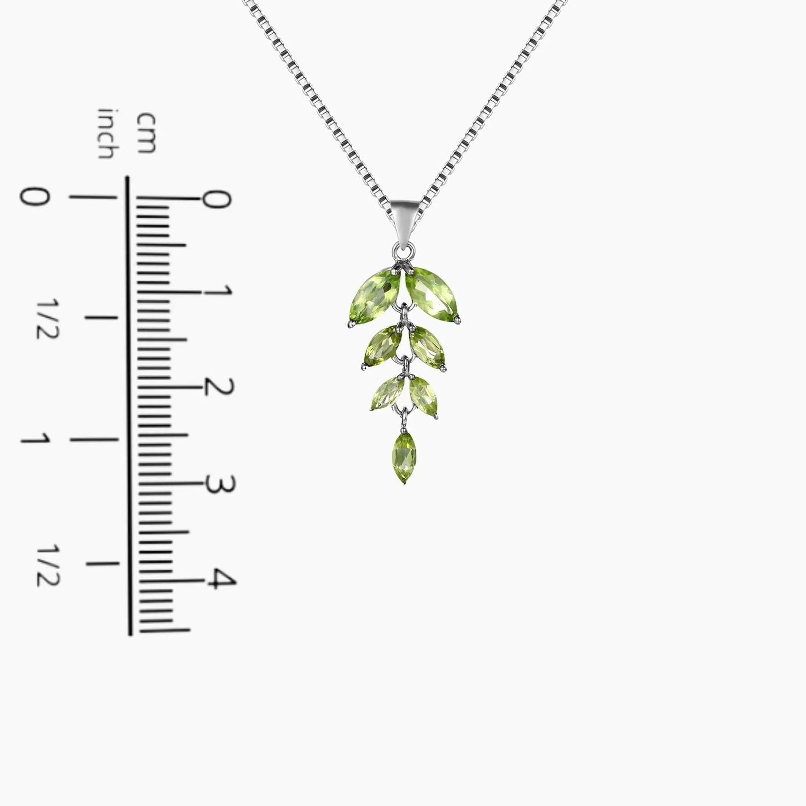Sparkling Peridot Leaf necklace on a scale