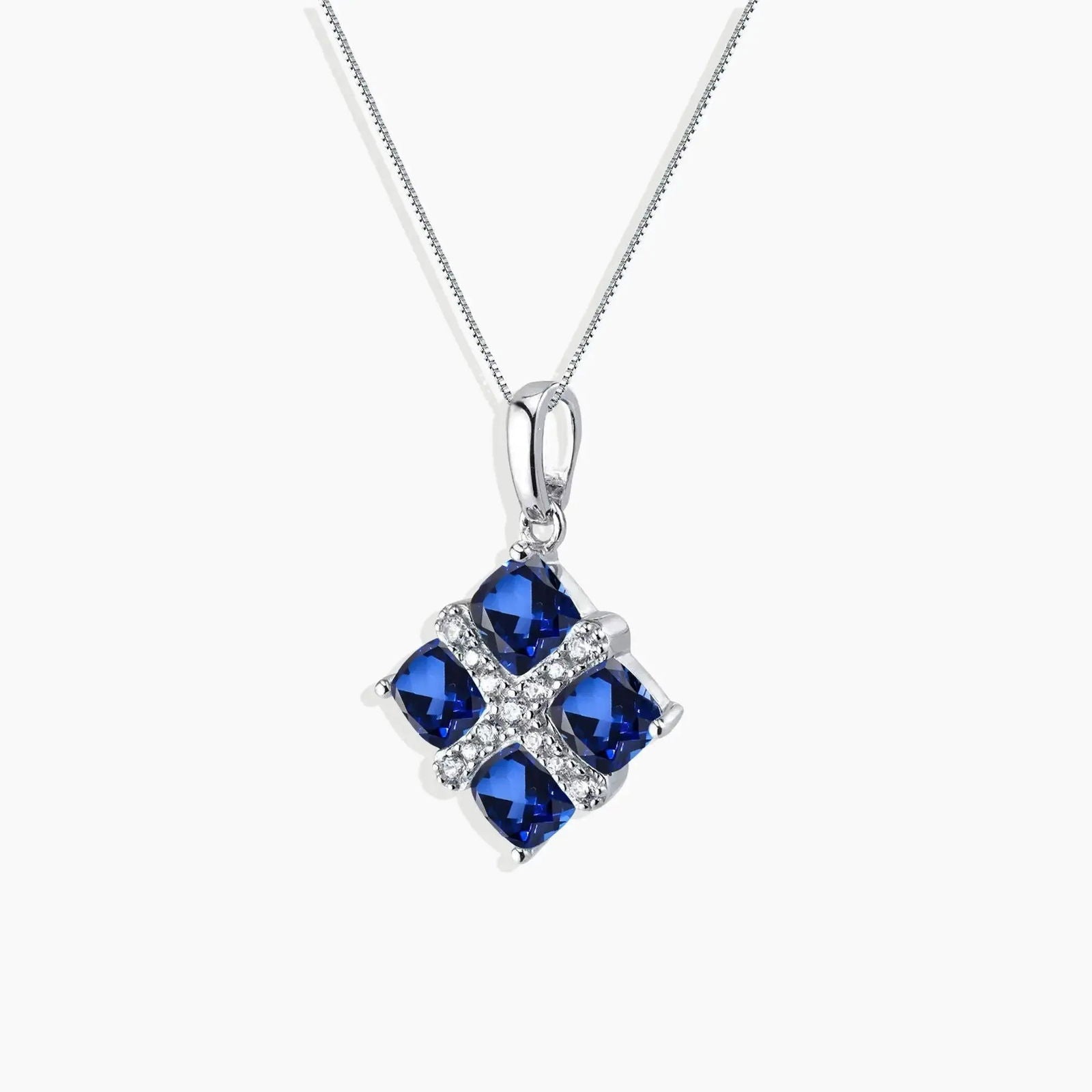 Square sapphire necklace in sterling silver with four vibrant blue gemstones, perfect for adding elegance to any outfit.
