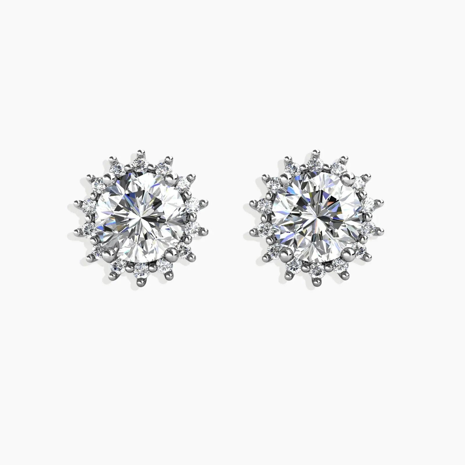 A pair of Sunburst Moissanite Round Stud Earrings on a gray background, featuring a radiant sunburst design