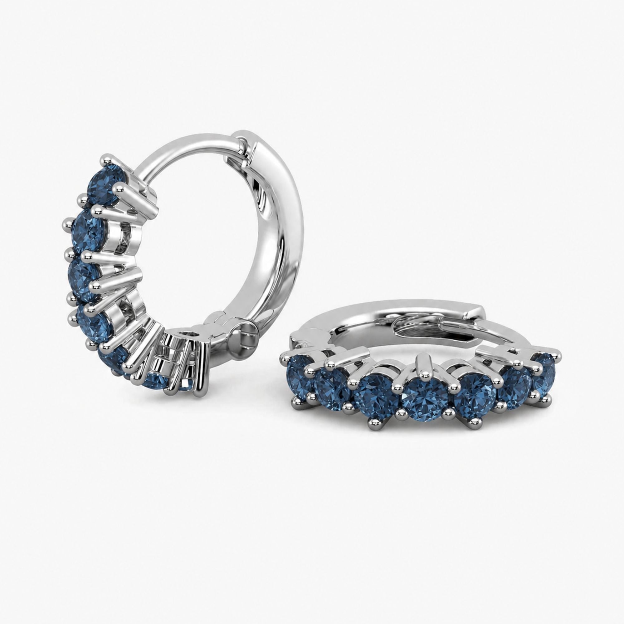 Silver hoop earrings with london blue topaz gemstones on a white background