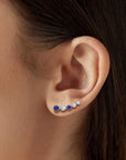 sapphire earrings climbers on model