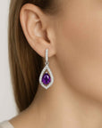 amethyst pear shape earrings dangling on model ear