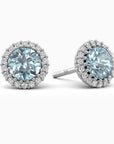 A pair of aquamarine halo stud earrings in 925 sterling silver with sparkling CZ accents.