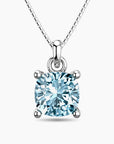 Round-cut aquamarine pendant necklace in sterling silver, featuring a sparkling pale blue gemstone in a four-prong setting on a fine chain.