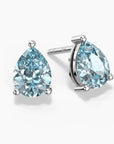 Teardrop-shaped aquamarine stud earrings in silver claw setting