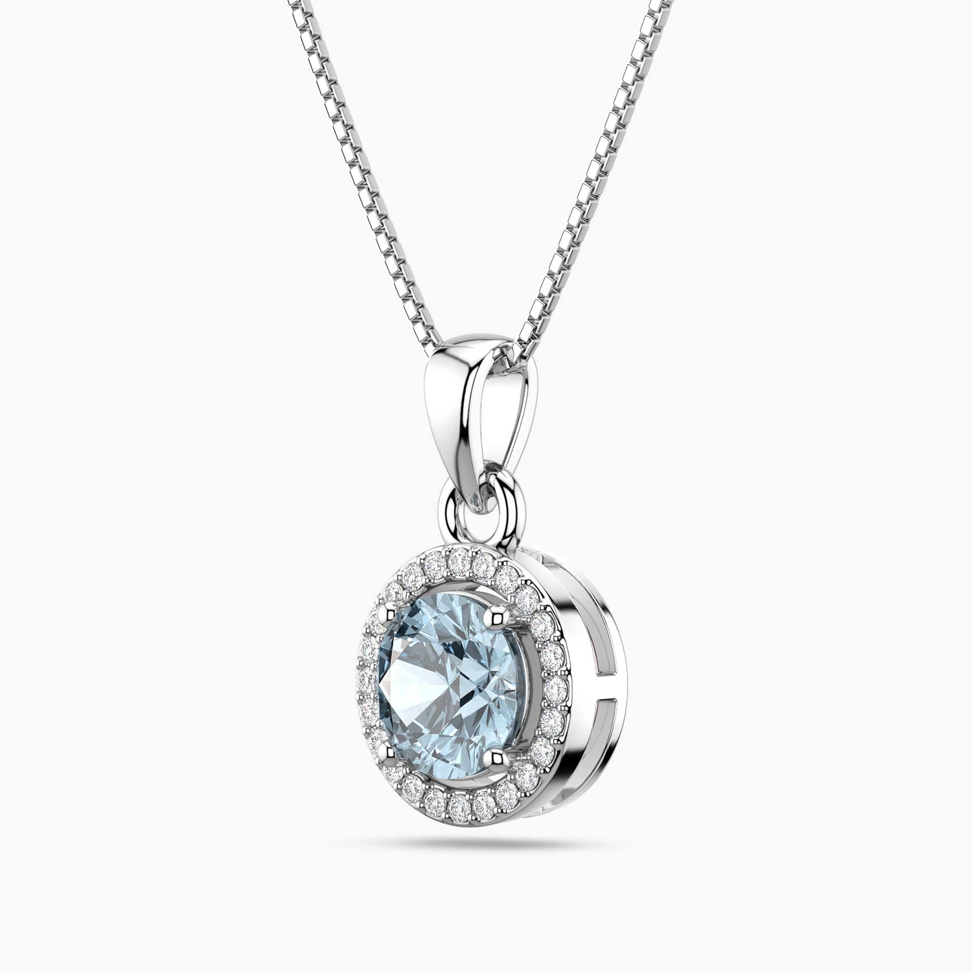 Silver pendant with a blue aquamarine gemstone and clear stones on a white background