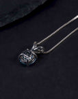 back side of aquamarine pendant necklace on dark background