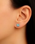 round aquamarine earrings on model