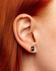 model featuring black opal earrings