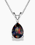 A pear-shaped black opal pendant showcasing vibrant play-of-color flashes of red, green, and orange, set in a three-prong polished sterling silver V-shaped bail, hanging from a delicate silver box chain on a white background.
