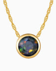 Bezel Set Black Round Opal Necklace in Gold by Irosk ® - Elegant fine jewelry featuring a round black opal pendant set in 18K real gold-plated silver