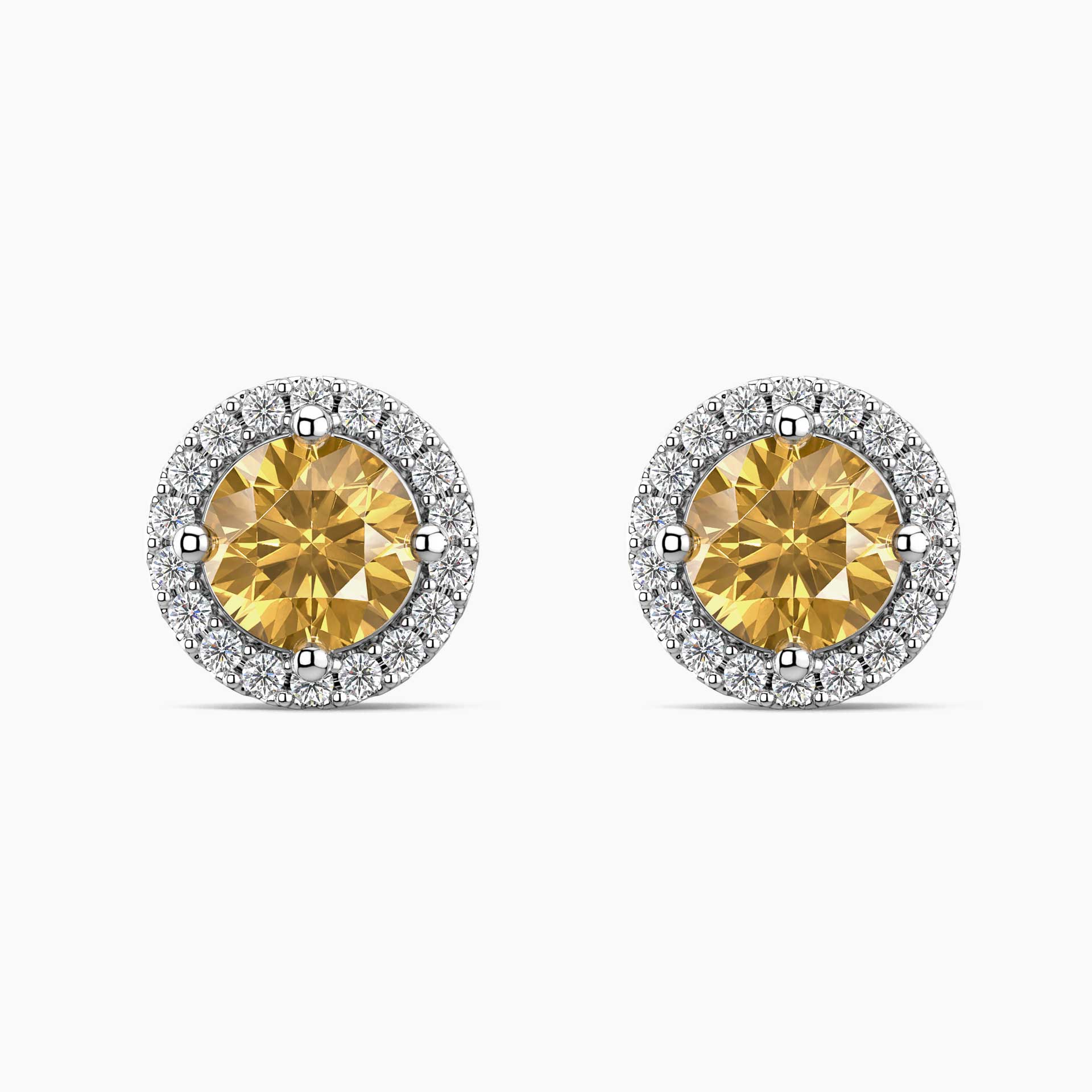 Pair of yellow citrine gemstone earrings with diamond halo on a white background