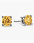 Pair of yellow citrine gemstone stud earrings on a white background