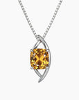 Silver pendant with a yellow gemstone on a white background