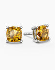 Cushion-cut citrine stud earrings in sterling silver, showcasing vibrant golden-yellow gemstones in classic four-prong settings.