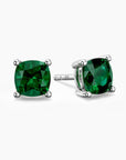 Cushion-cut emerald stud earrings in sterling silver, showcasing vibrant green gemstones held by a classic four-prong setting.