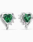 Pair of sterling silver heart-shaped emerald stud earrings with sparkling accent stones.