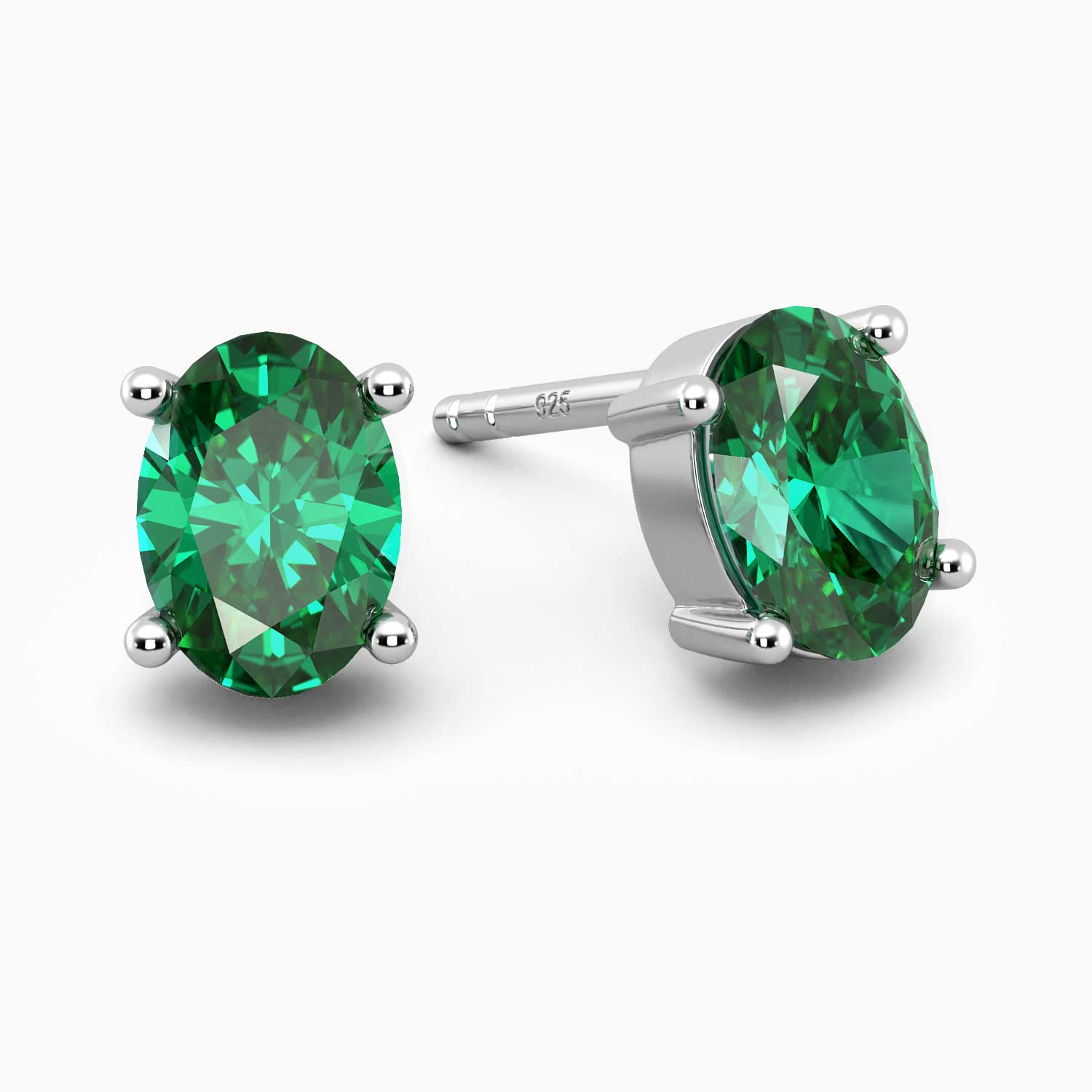 Sterling silver stud earrings featuring oval-cut emeralds on a white background.