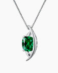 Silver pendant with a green gemstone on a white background