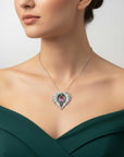Woman wearing a necklace with a green dress on a neutral background