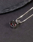 garnet round shape necklace on black background