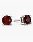 Pair of red garnet gemstone stud earrings on a white background