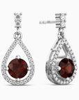 Teardrop-shaped earrings with red gemstones and diamond accents on a white background