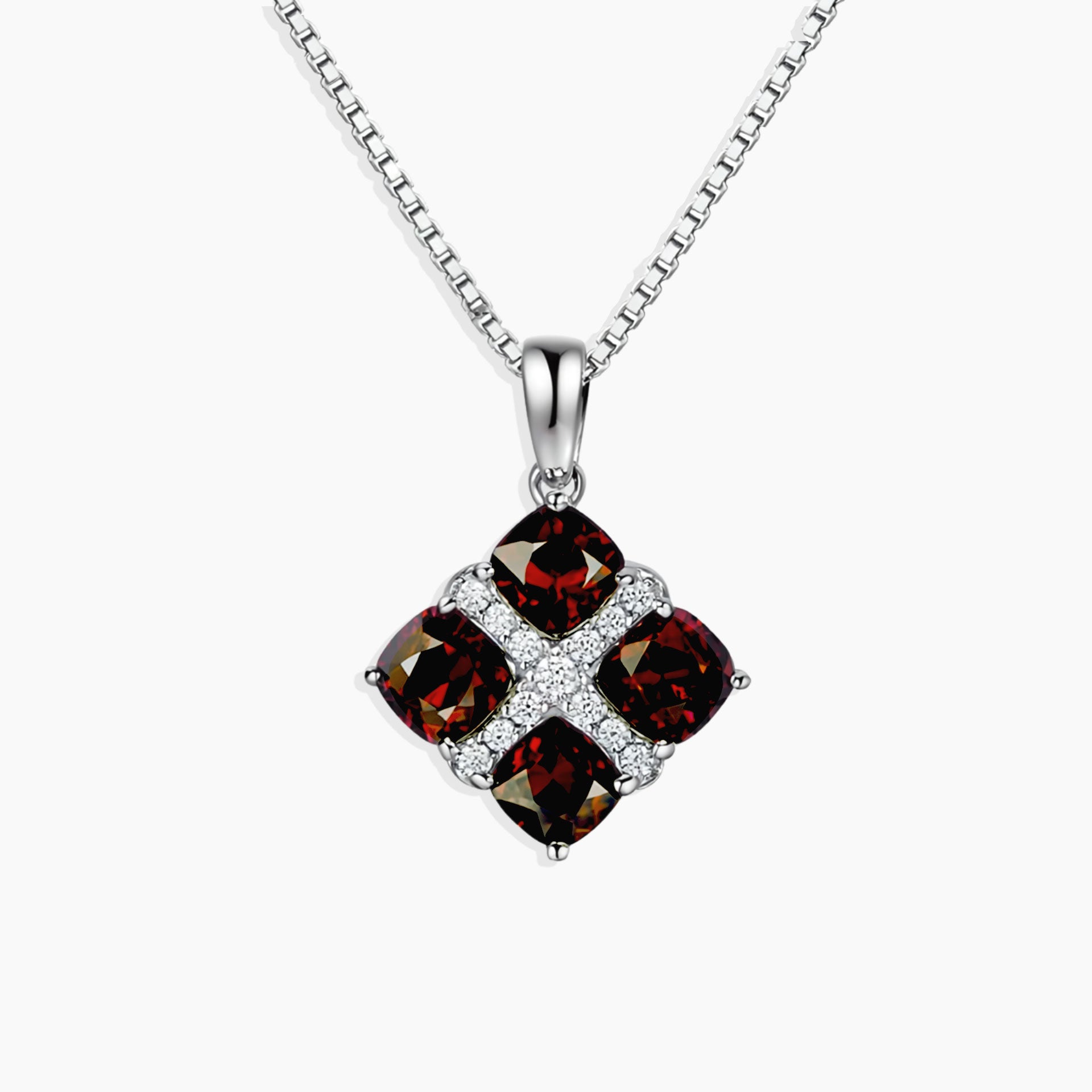 Garnet Cluster Pendant with four cushion-cut natural garnets set in rhodium-plated sterling silver on a 45 cm box chain.

