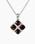 Garnet Cluster Pendant with four cushion-cut natural garnets set in rhodium-plated sterling silver on a 45 cm box chain.

