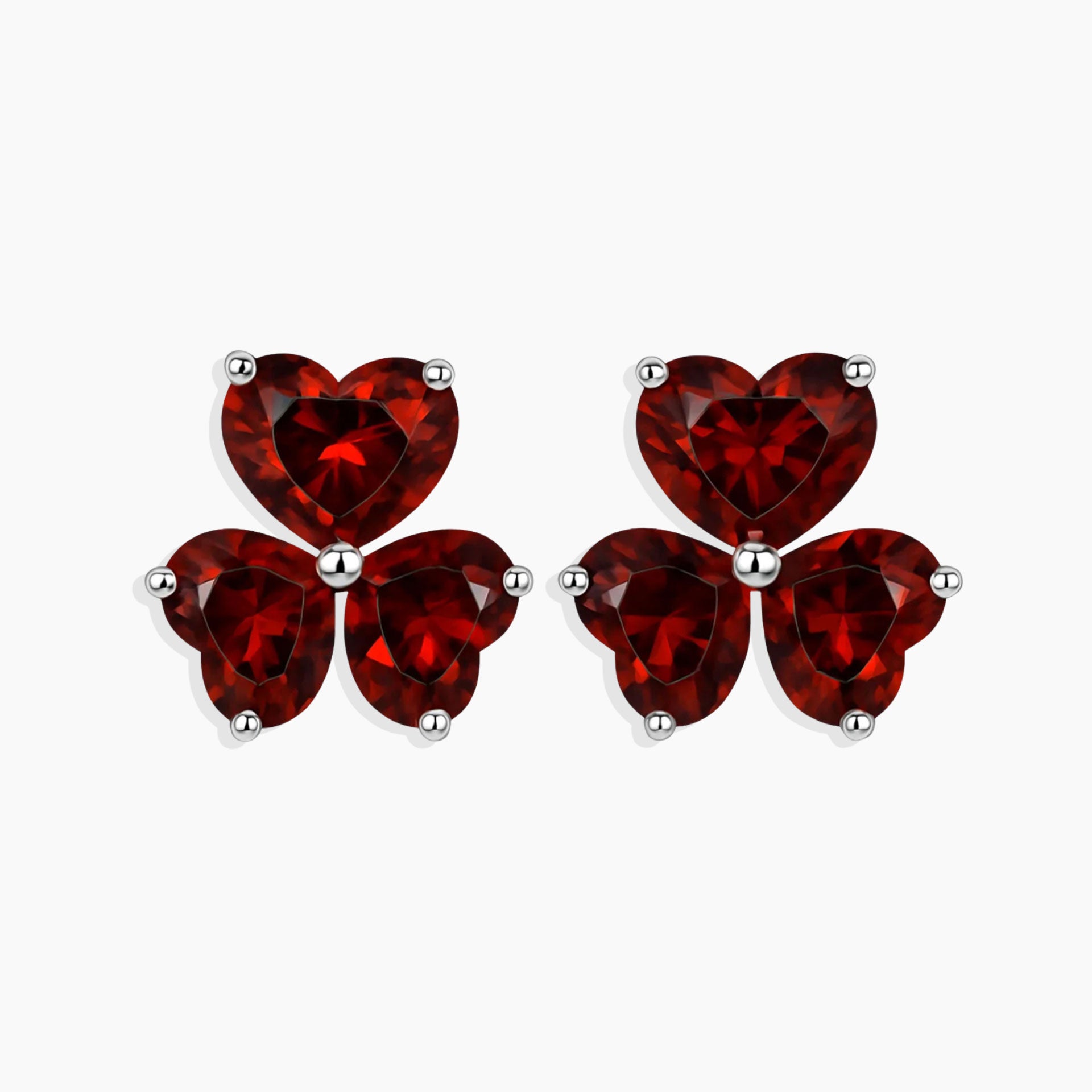Red heart-shaped earrings on a white background