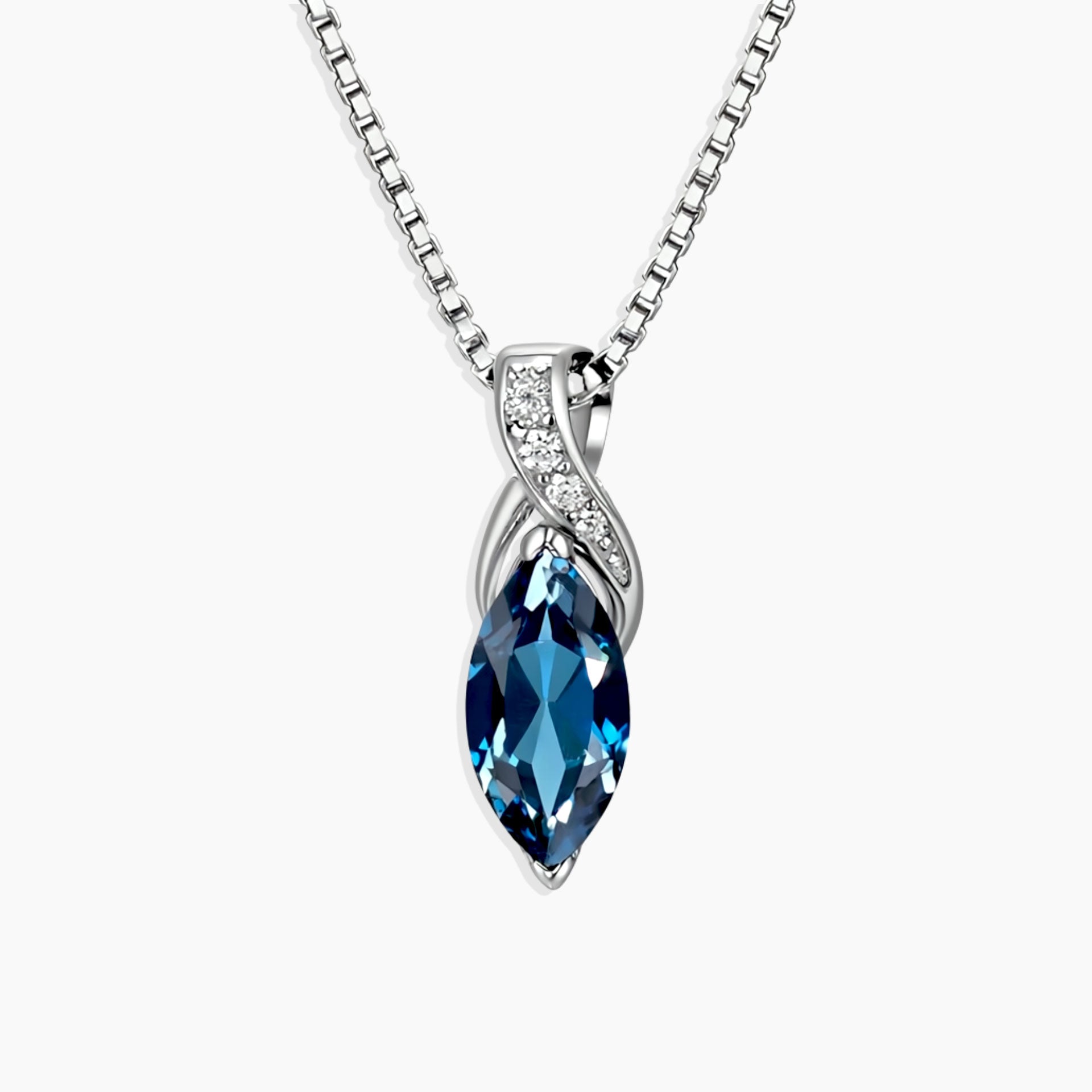 london blue topaz pendant on a silver chain against a white background