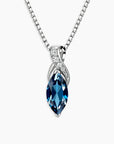 london blue topaz pendant on a silver chain against a white background