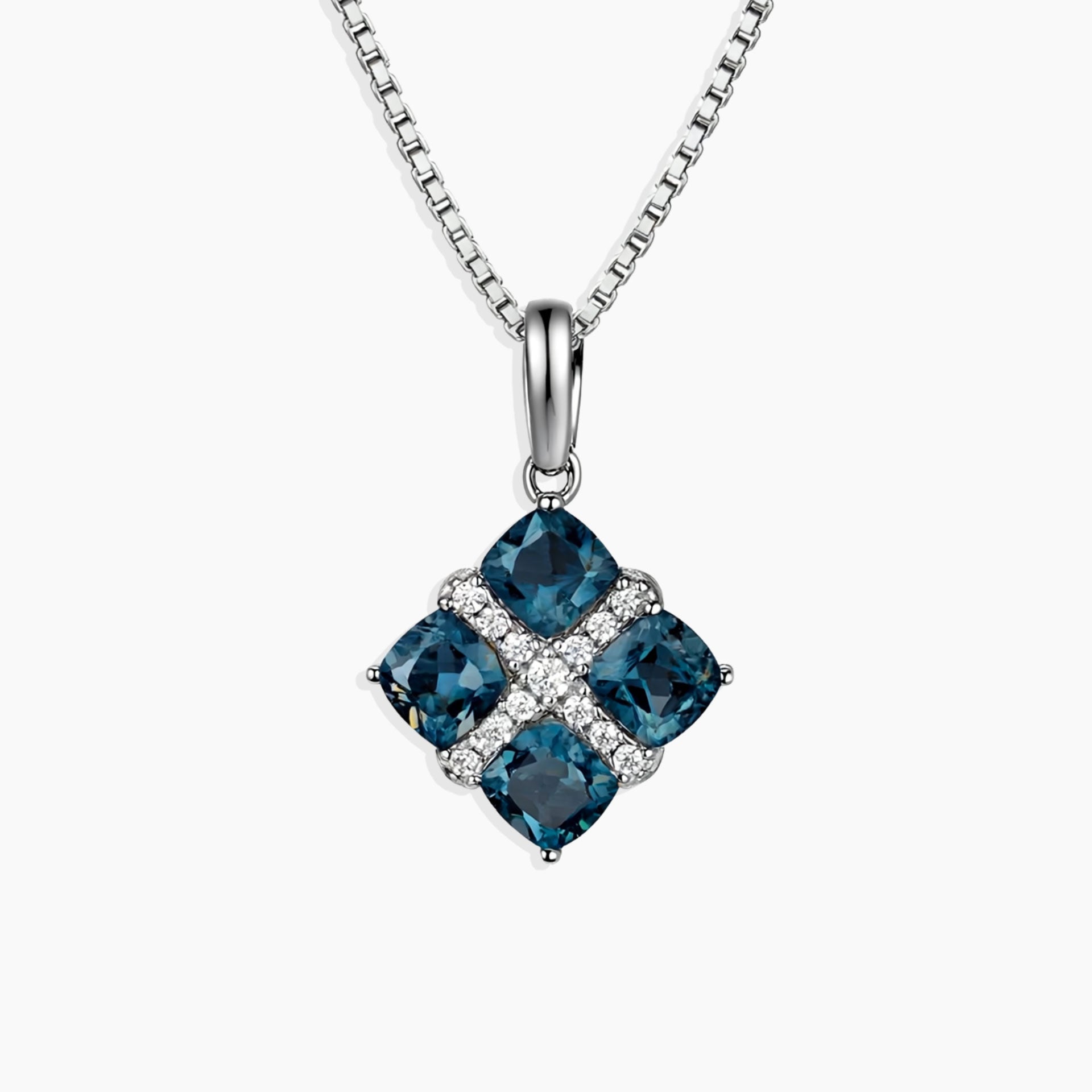 London Blue Topaz Cluster Pendant featuring four cushion-cut topaz stones set in rhodium-plated sterling silver with box chain.

