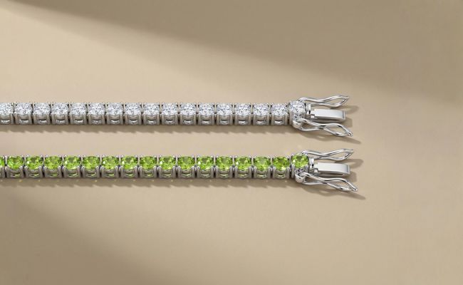 peridot and moissanite tennis bracelets sitting next to each other on plain base
