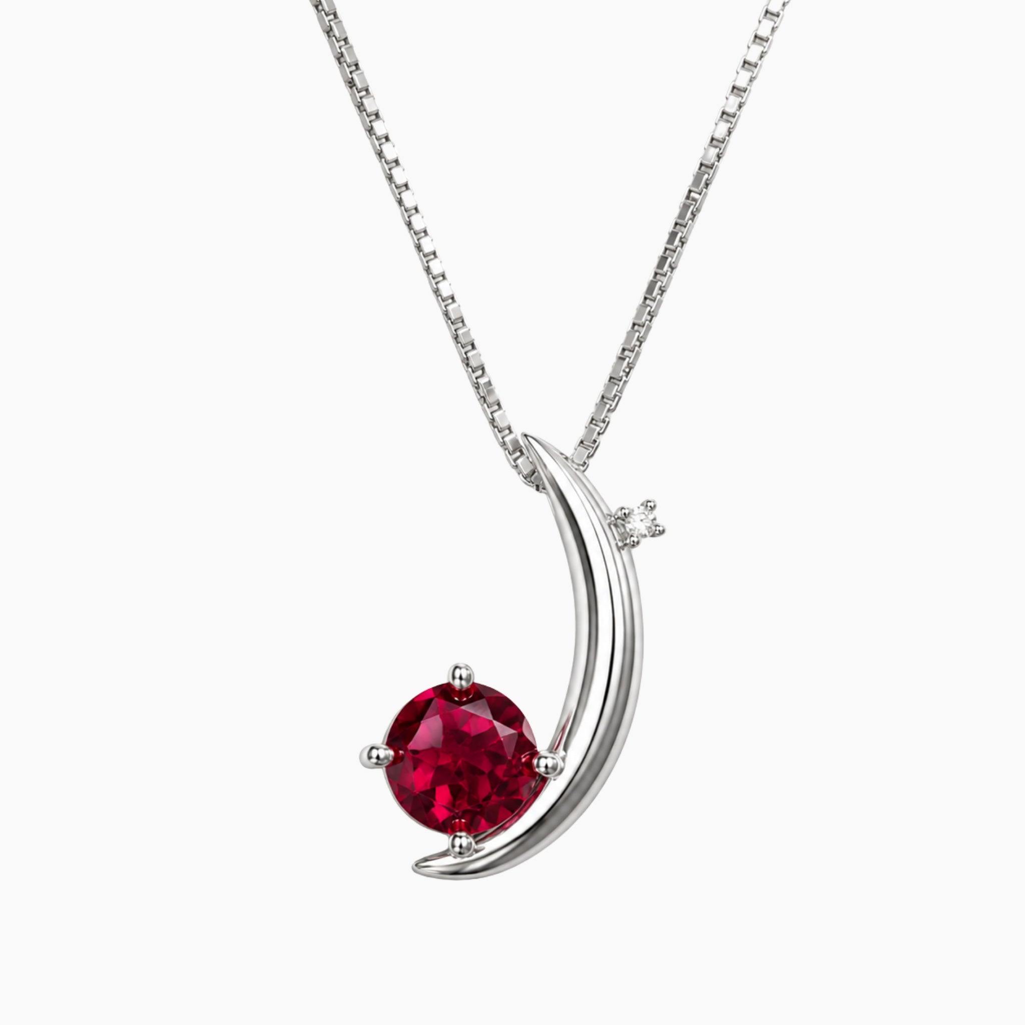 Silver necklace with a red ruby moon  pendant on a white background