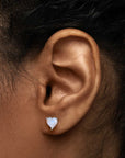 Heart-shaped moonstone stud earring worn on ear – natural June birthstone jewellery in sterling silver