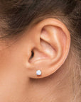 Natural moonstone stud earring worn on ear – dainty and elegant everyday jewellery for women