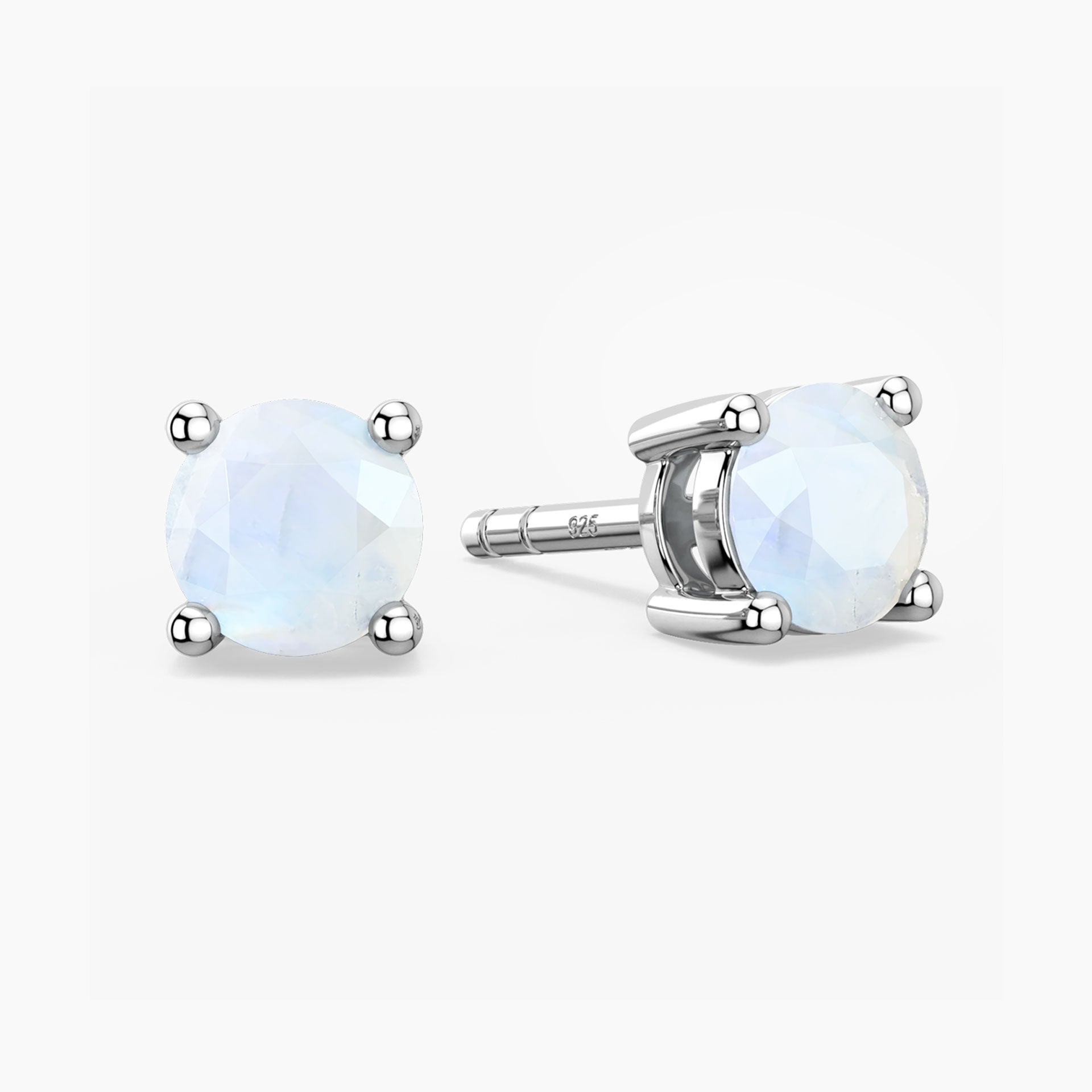 Pair of silver stud earrings with round gemstones on a white background