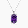 Oval-cut purple amethyst pendant in a four-prong silver setting, suspended from a delicate silver chain, displayed on a white background