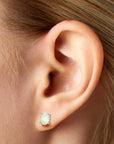 model featuring silver opal earrings