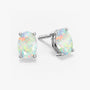 Pair of oval-cut white opal stud earrings with iridescent rainbow flashes, set in four-prong silver settings with push-back closures, displayed on a white background