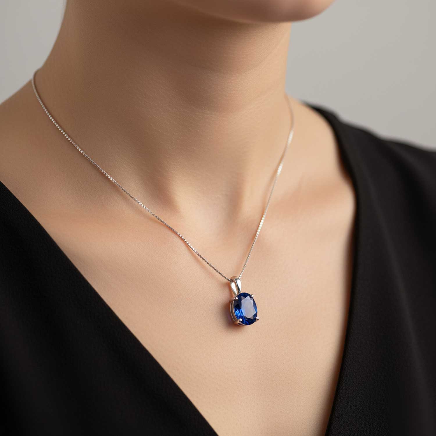 Necklace with a blue pendant on a mannequin