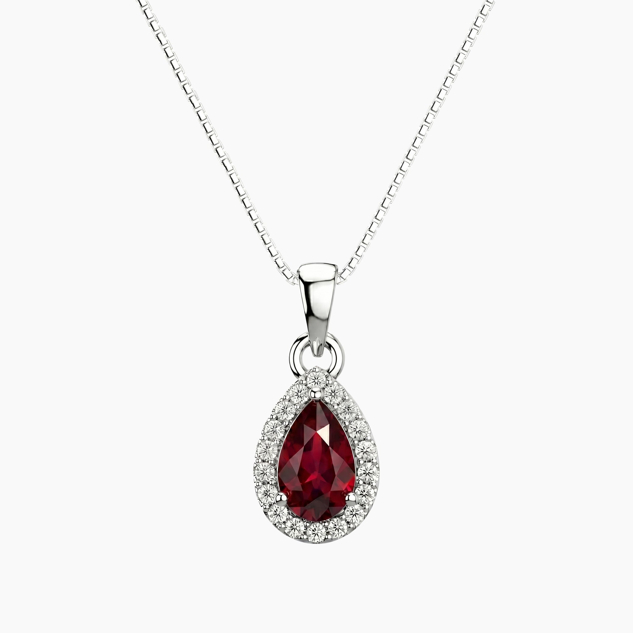 Silver necklace with a red teardrop ruby pendant on a white background